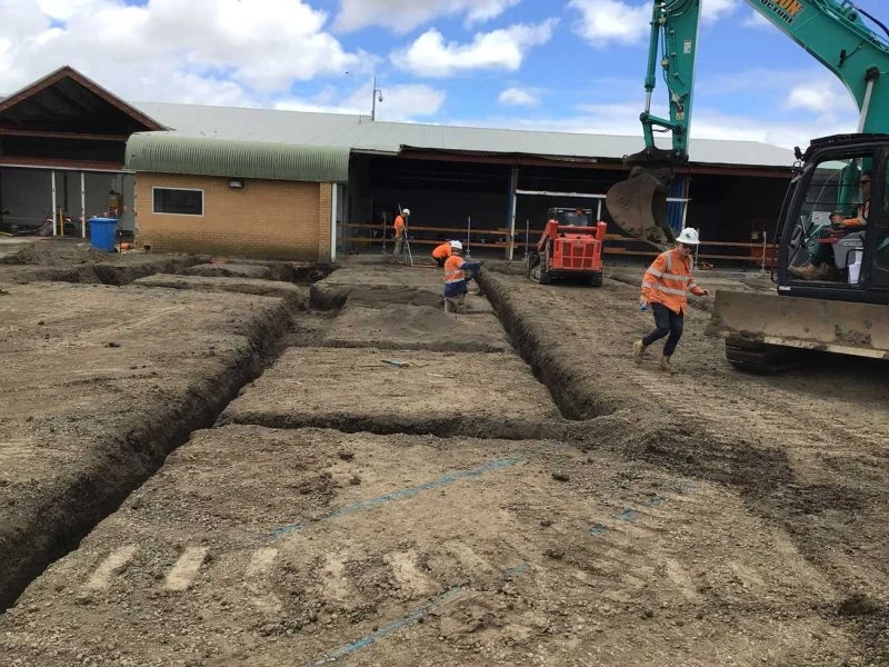 Excavation trenches and machinery at a construction site