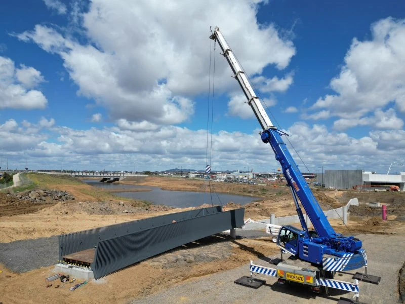 Mobile crane lifting a precast bridge component