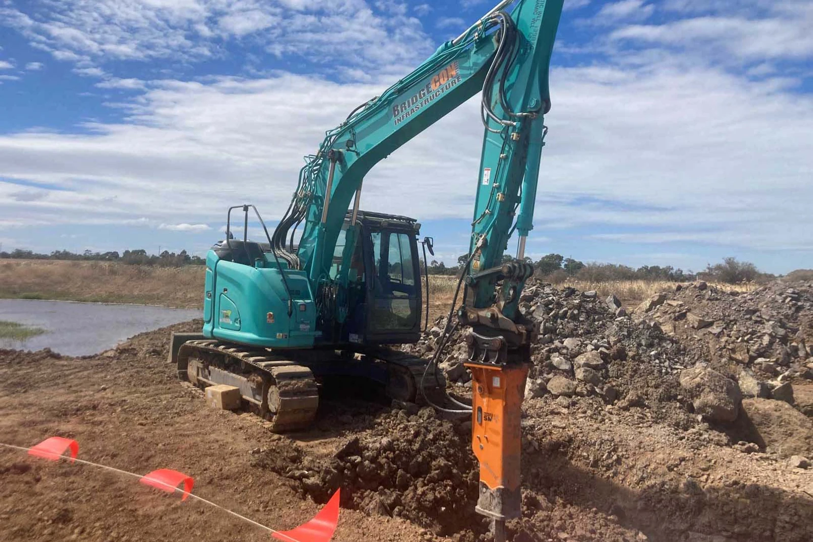 Excavator with an auger attachment for foundation work